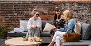 A group of three women enjoying the Queens Hotel gardens