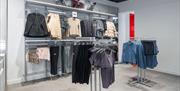 Clothing for sale and changing rooms at New Balance Gunwharf Quays