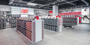 Trainers and footwear on display at the New Balance outlet in Gunwharf Quays