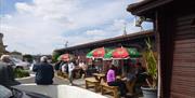 Outdoor seating area for drinks at Kingfisher Caravan Park