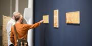 Two people looking at an installation at Aspex Portsmouth, by photographer Daniel Boss