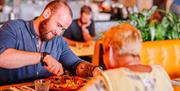 A man and a woman tuck into their Pizza Express meal