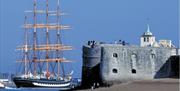 Image of visitors watching naval vessels from the Round Tower