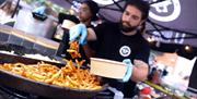 Street food chef plating up chips