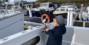 Young girl on a boat with a fishing rod