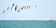 Kite surfing out in the Solent, photograph by Vernon Nash