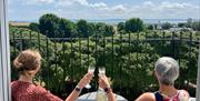 Two ladies toast the view from the balcony of Skyline Oasis