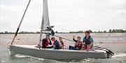 A group of people on a small yacht at the Andrew Simpson Centre in Portsmouth