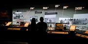 Two people taking in the view of displays at The D-Day Story