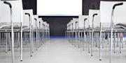 Stock image of chairs set for a meeting in a conference hall