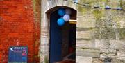 Balloons and bunting to welcome visitors through the archway into the Round Tower. Copyright Rachel James.