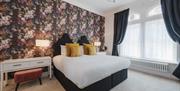 Modern floral wallpaper decorating a room at Somerset House Boutique Hotel and Restaurant