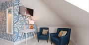 Relaxing seating area in a bedroom at Somerset House Boutique Hotel and Restaurant
