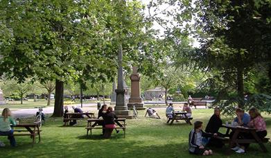 People enjoying the benches at Victoria park