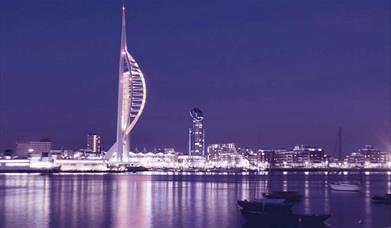 Photograph of the Portsmouth skyline in the R;pple Effect charity's purple colour