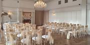Room at Queens Hotel set up for a wedding or other ceremony
