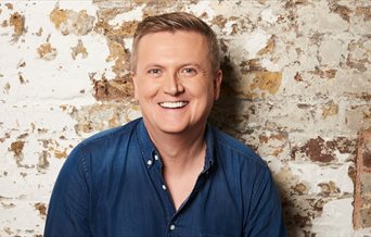 Press photo for Aled Jones: Full Circle featuring the singer against a bare brick wall
