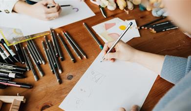 Stock image of people illustrating at an art course