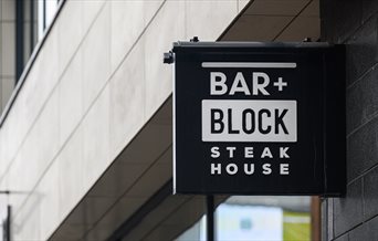 Exterior sign for Bar + Block Steak House