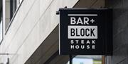 Exterior sign for Bar + Block Steak House