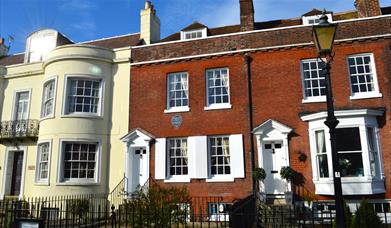 Photograph showing the exterior of the Charles Dickens' Birthplace Museum under a blue sky