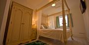 Image of a bedroom with a four poster bed.