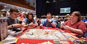 Group of people playing a board game at the Guildhall Games Fest