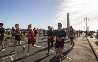 People taking part in the Great South Run, going past the War Memorial on Southsea Seafront