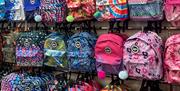 Colourful backpacks lined up on racks at the Hype outlet in Gunwharf Quays