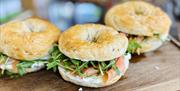 Three salmon bagels with rocket