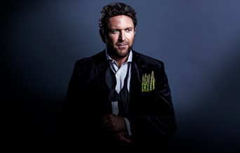 Poster for James Martin Live showing the chef in a suit jacket with asparagus spears in place of a pocket square
