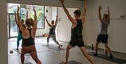 Five people taking part in a Yoga session at LANO Yoga in Southsea