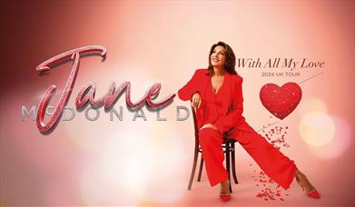 Poster for Jane McDonald - With All My Love, featuring the singer sat on a chair and wearing a red outfit