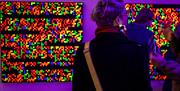 Person at a multi-coloured exhibition at Aspex Portsmouth, by photographer Paul Gonella