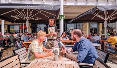 Two people dining al fresco at Pizza Express in Gunwharf Quays