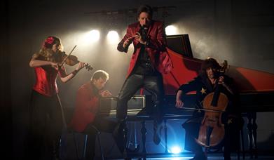 Press shot showing Red Priest mid-performance