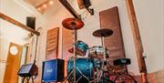 Photograph of Room 2 at Southsea Sound, with the Natal drum kit set up and amps ready