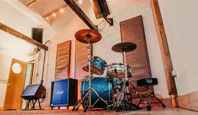 Photograph of Room 2 at Southsea Sound, with the Natal drum kit set up and amps ready