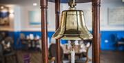 Decorative bell in the dining area of Royal Maritime Hotel & Club