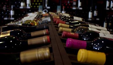 Photograph of bottles of wine racked in a shop