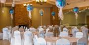 Stock image of a hall set for a christening, with tables set in white and blue