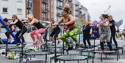 A group of people at the Sweat Festival in Portsmouth doing a trampolining class