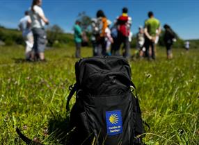 Rucksack with Camino de Santiago logo on grass