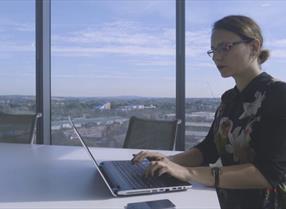 woman working on a laptop in an office