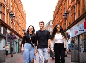 Friends walking through Reading town centre
