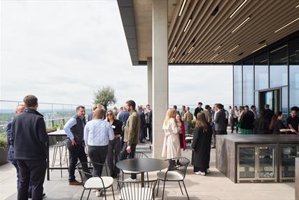 Group of business people networking on the terrace of ONE Station Hill in Reading