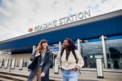 Two young women walking out of Reading Train Station