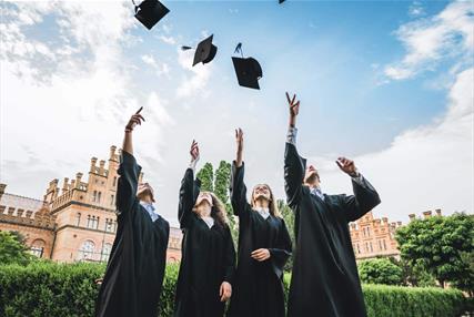 Group of university students throwing their hats