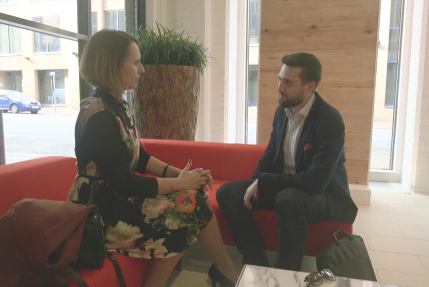 two people talking in office reception area