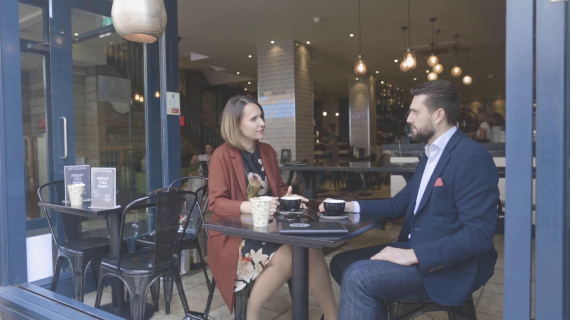 two people sitting in coffee shop window